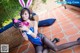 A woman in a bunny costume holding a toy gun.