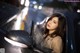 A woman leaning out the window of a car at night.