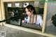 A woman holding a rifle in an abandoned building.